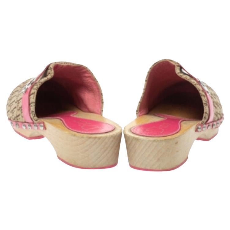 These clog slides from Dior are trendy and easy to slip on. Made in Italy, they feature Diorissimo-printed canvas vamps accented with leather straps that carry logo detail. The pair is complete with studs on the midsoles and a set of low heels. This