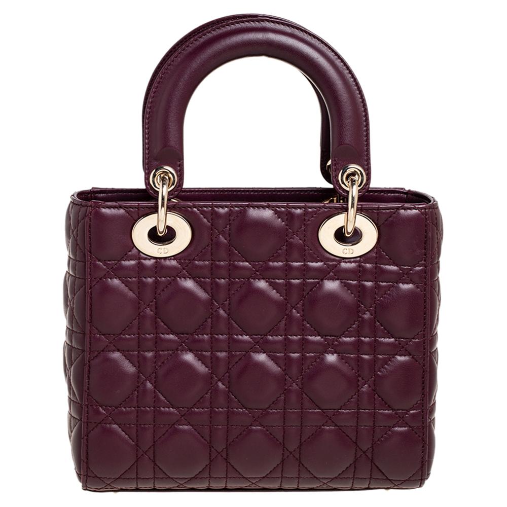 The Lady Dior tote is a Dior creation that has gained recognition worldwide and is today a coveted bag that every fashionista craves to possess. This plum tote has been crafted from leather and it carries the signature Cannage quilt. It is equipped
