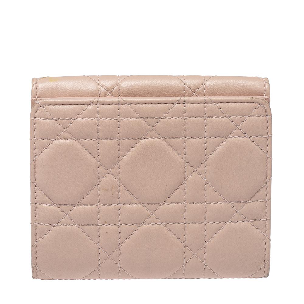 The exquisite Dior Dioraddict French wallet is a smart creation to secure your belongings with grace and comfort. The pink Cannage-detailed leather wallet opens on one side with a flap. The other side opens to a bifold wallet with sections made to