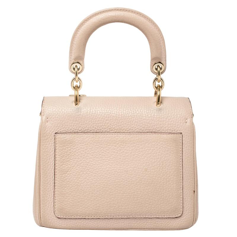 This Be Dior bag from the house of Dior is sure to add sparks of luxury to your wardrobe! It is crafted from leather and features a chic silhouette. It flaunts a single top handle with attached 'DIOR' letter charms and comes equipped with protective