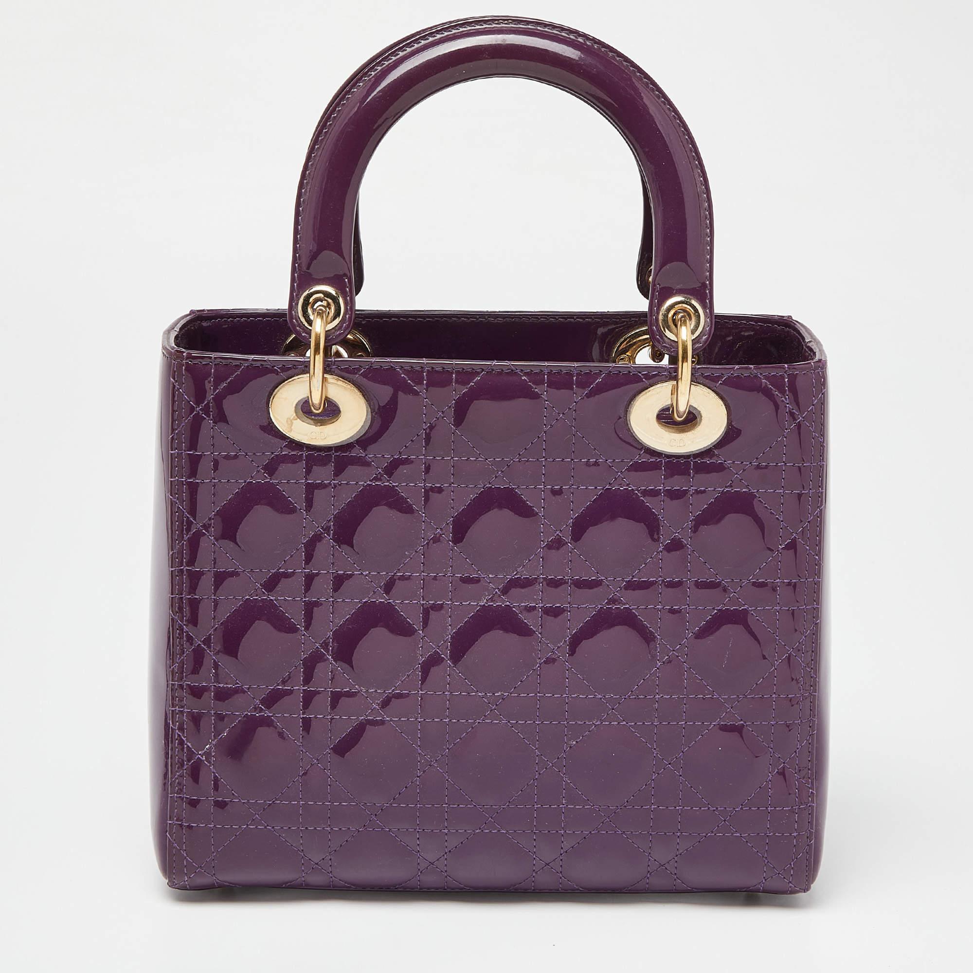 The Lady Dior tote is a Dior creation that has gained wide recognition and is a coveted bag that every fashionista craves to possess. The purple tote has been crafted from patent leather and carries the signature Cannage quilt. It is equipped with a