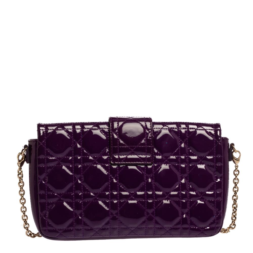 Flap bags like this Miss Dior will never go out of style. Crafted from patent leather, this Dior flap bag features a purple Cannage exterior and a chain strap. The front flap has a Dior lock that opens to a leather-lined interior with enough space