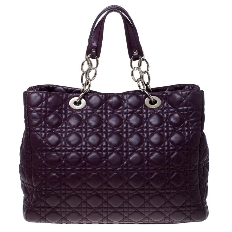 This shopper tote from Dior is a timeless piece. The bag is crafted from luxurious purple quilted leather and has the cannage pattern. It features double top handles, protective feet at the bottom and Dior letter charms in silver tone. A buttoned