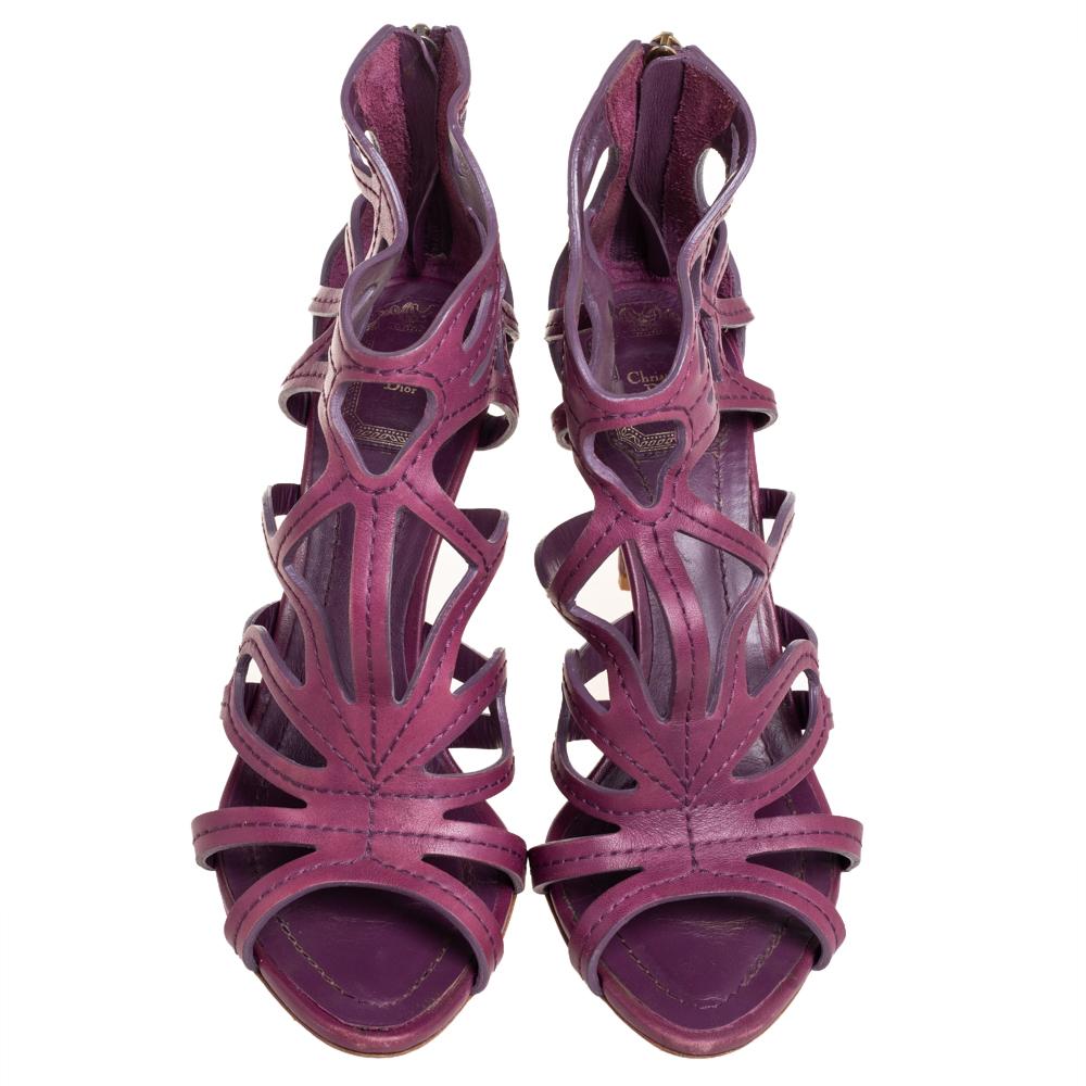 Flaunt style at its best with these beautiful sandals from Dior. They are crafted from leather and laid in a style of cutouts with back zippers, peep toes, and 9 cm heels. These mesmerizing purple sandals will complement all your favorite