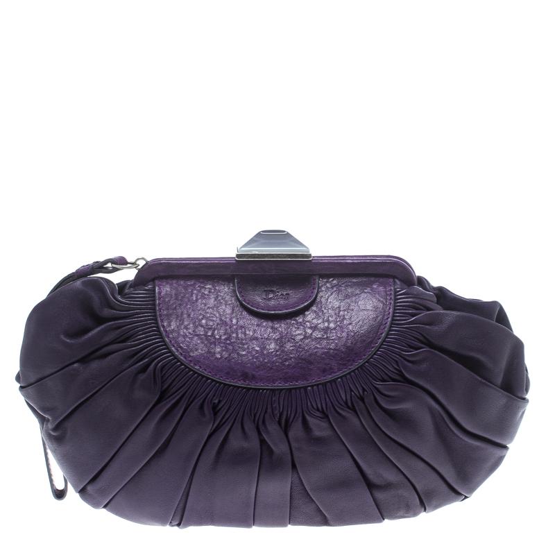 This frame clutch by Dior is crafted from purple leather and features pleats on the exterior. Its construction provides long-lasting use and it comes with a wristlet. The interior is canvas lined and will safely hold your belongings.

Includes: