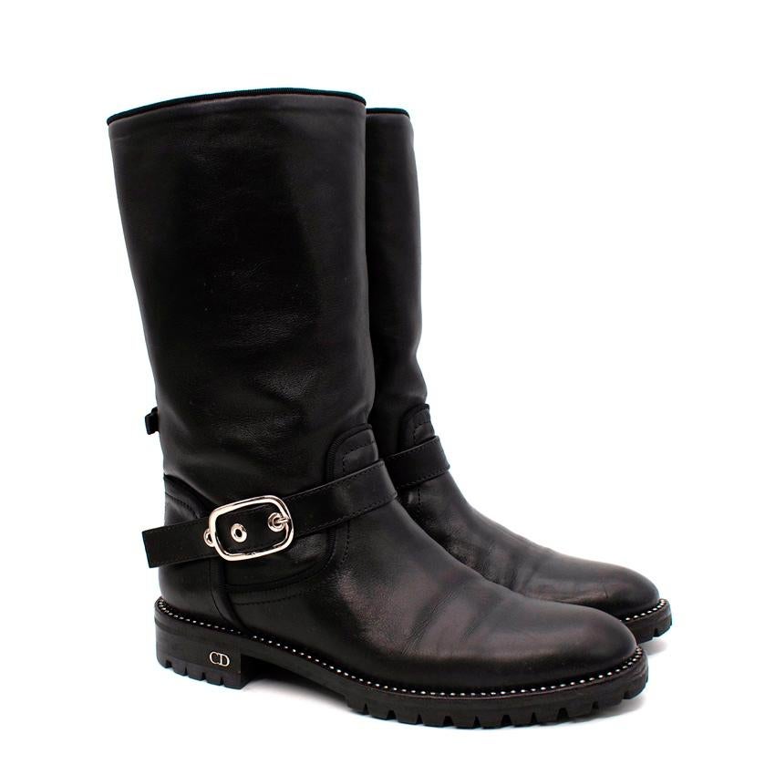Dior Rebelle Black Leather Biker Boots
 

 -Make a statement with these Dior Biker Boots.
 -Silver buckle
 -Rhinestones
 -Solid colour
 -Round toe-line
 -Square heel
 -Leather lining
 -Lug sole
 

 Materials 
 100% Leather 
 

 Made in Italy. 
 

