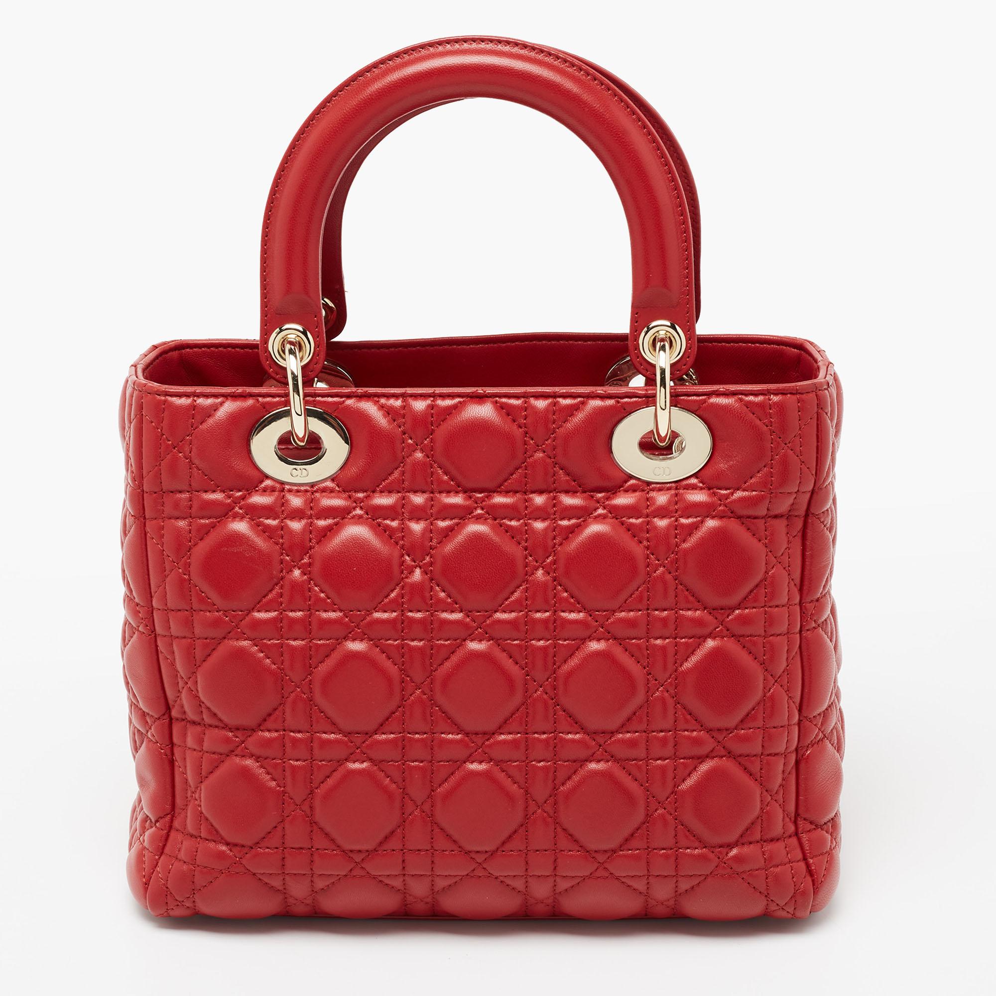 A timeless status and great design mark the Lady Dior tote. It is an iconic bag that people continue to invest in to this day. We have here this red Lady Dior tote crafted from Cannage leather. The bag is complete with two top handles, two shoulder