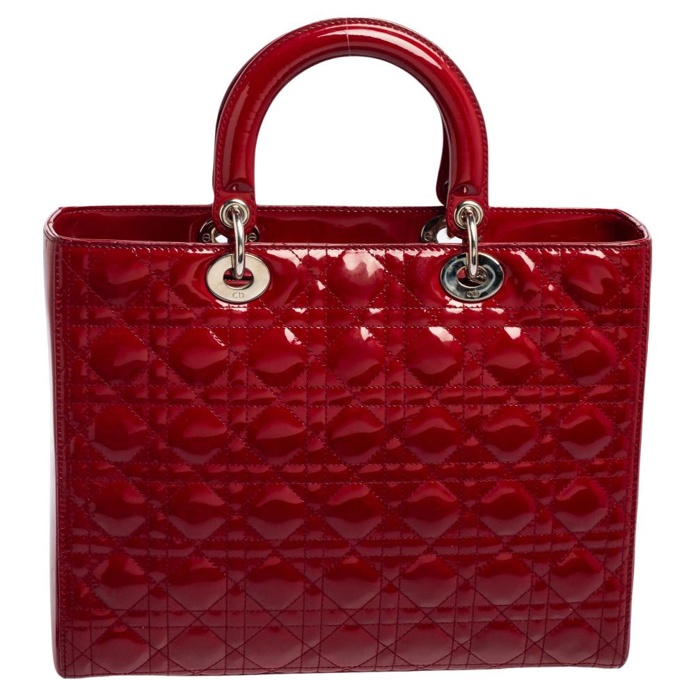 A timeless status and significant design define this impeccable Lady Dior tote. An iconic creation of the House, this tote brings eternal poise, gracefulness, and elegance to your appearance. This version comes crafted in red Cannage patent leather