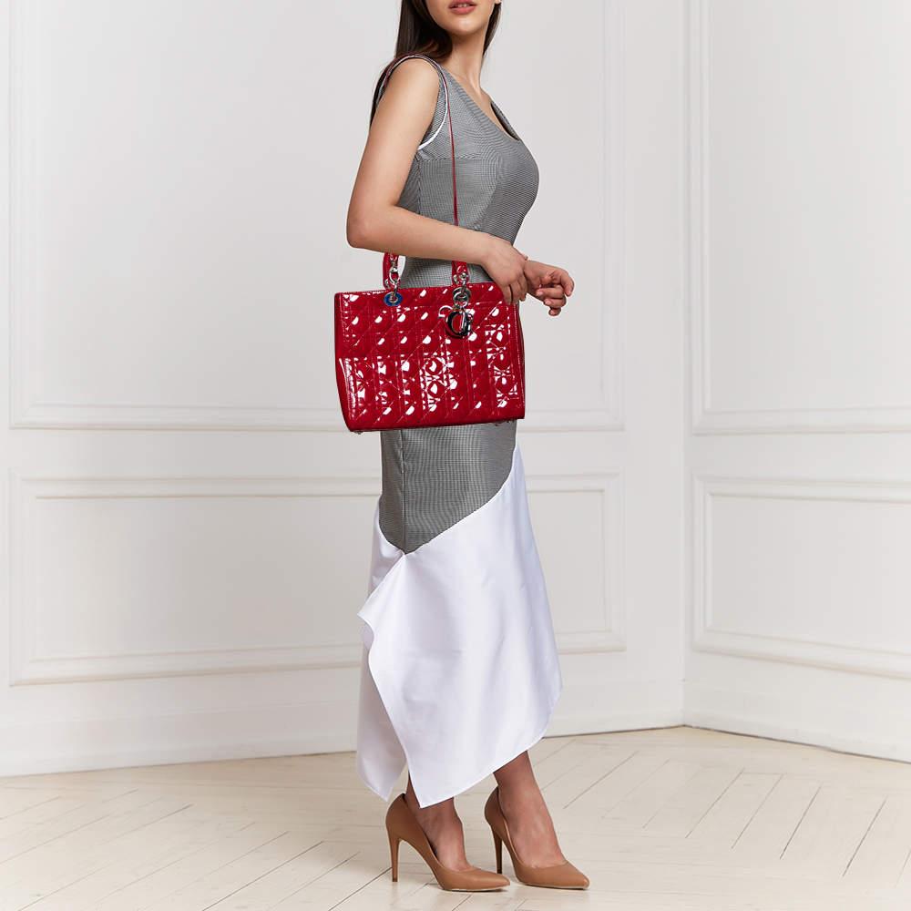 The Lady Dior tote is a Dior creation that has gained recognition worldwide and is today a coveted bag that every fashionista craves to possess. This red tote has been crafted from patent leather, and it carries the signature Cannage quilt. It is