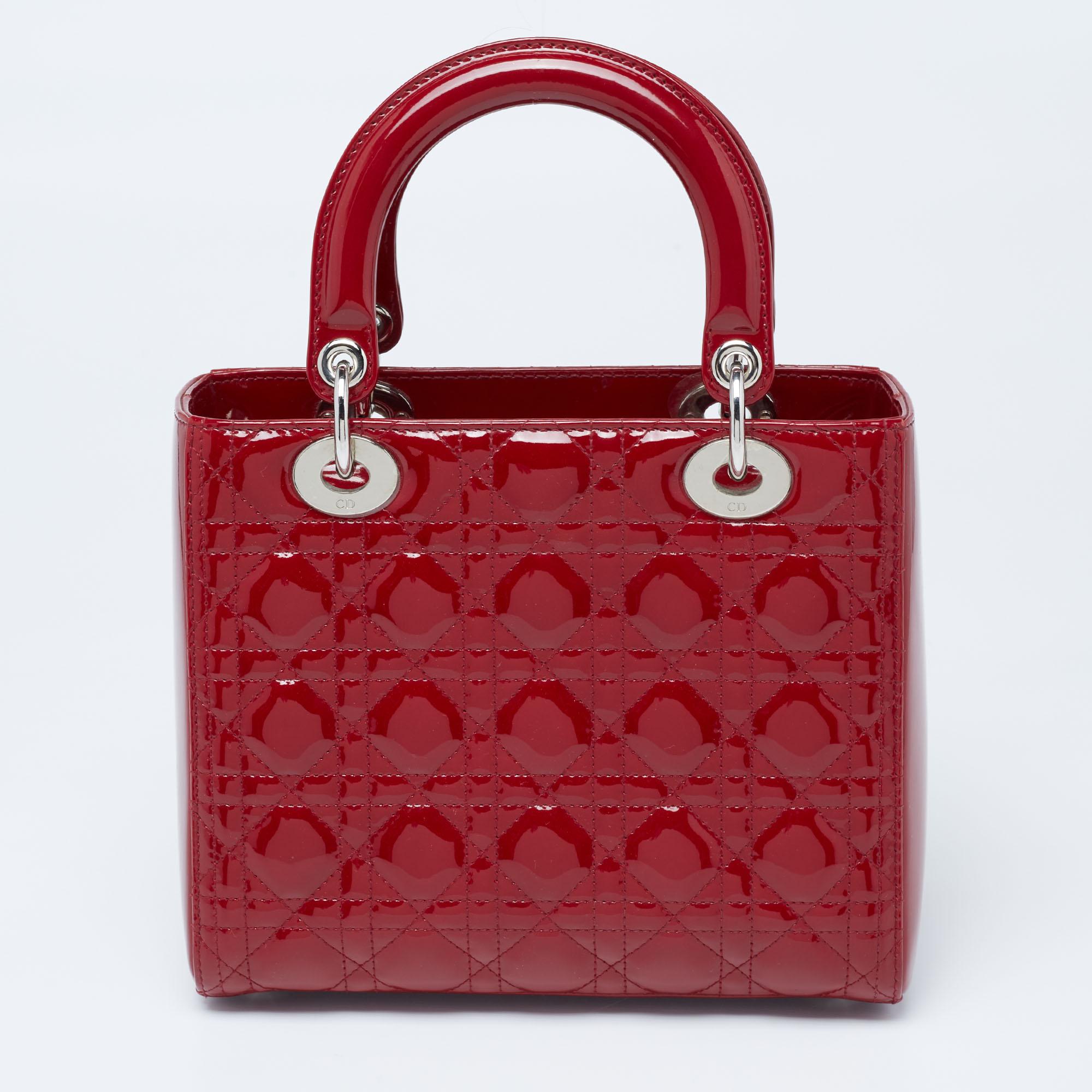 A timeless status and significant design define this impeccable Lady Dior tote. An iconic creation, this tote brings eternal poise, gracefulness, and elegance to your appearance. This version comes crafted in red Cannage patent leather, with