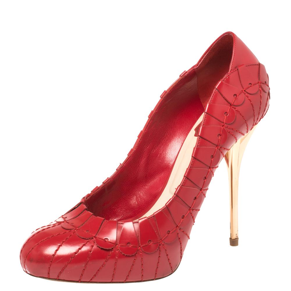 Look chic and make an elegant style statement in this pair of pumps from the house of Dior. They are crafted from leather in a red hue featuring almond toes, high heels, and embroidered detailing all over. Add a touch of sophistication to your look