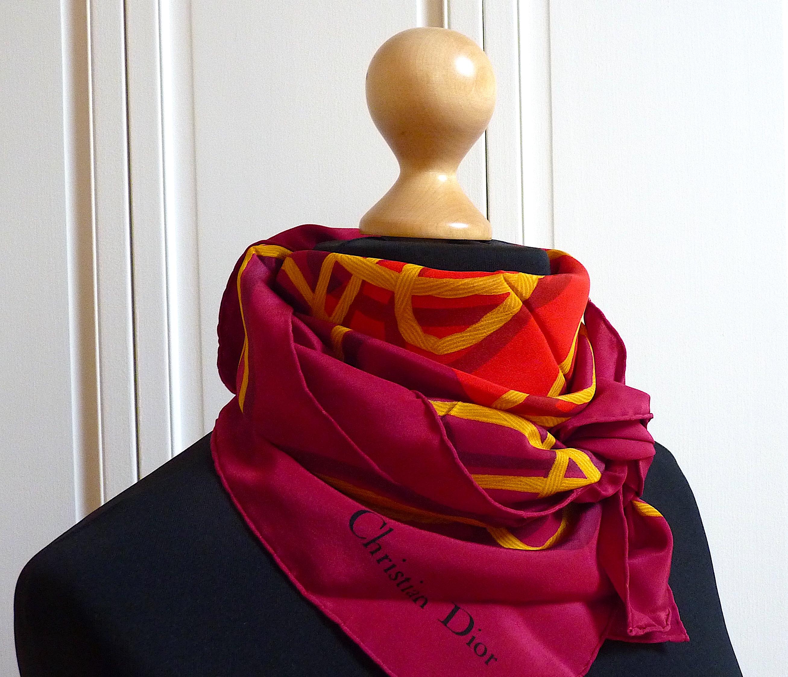 This is a Vintage DIOR  Silk Scarf, featuring a central gold Medallion written Maison christian Dior Paris 30 Avenue Montaigne and the name DIOR in gold Letters upper side

Signed Christian Dior in the bottom right corner

100% silk, no
