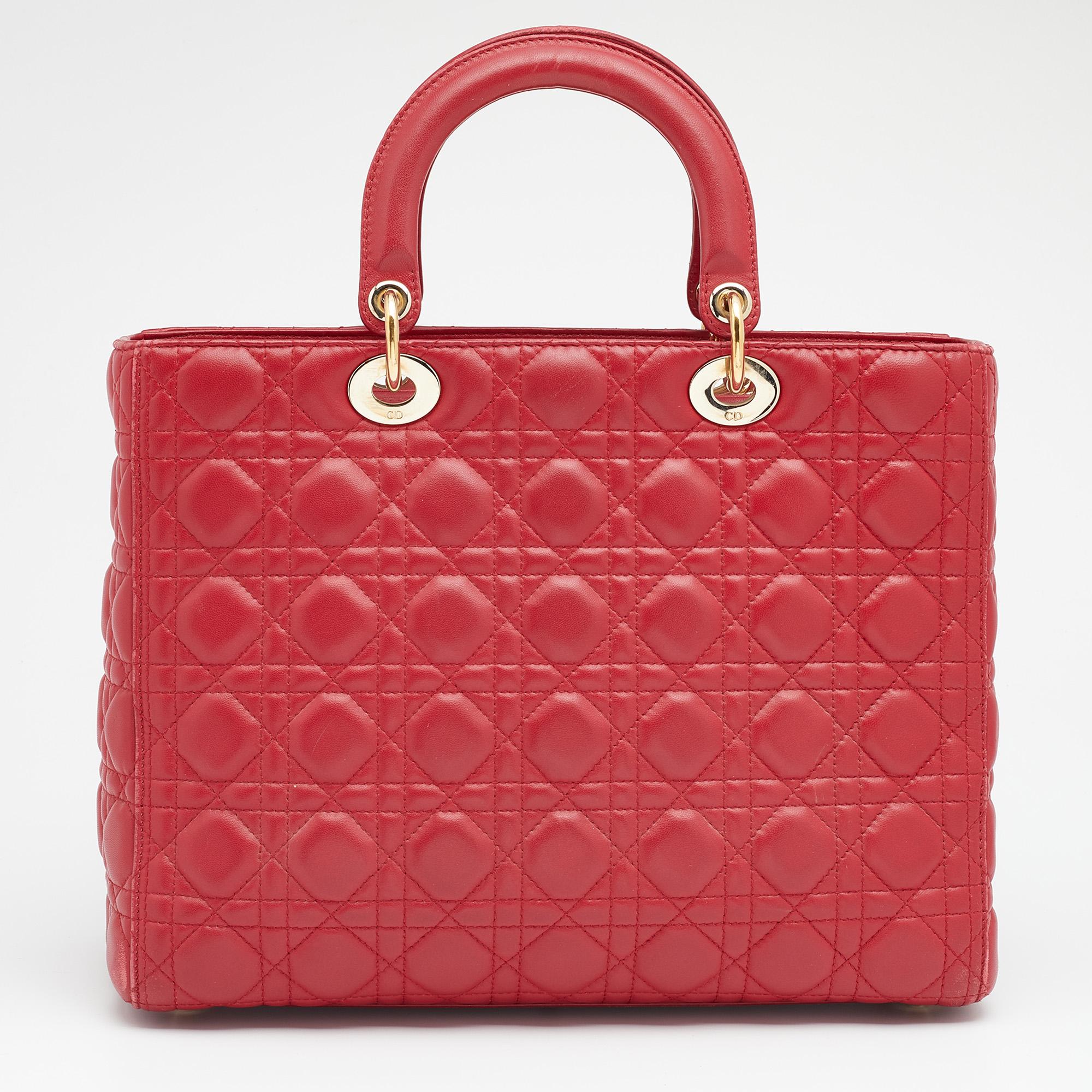 The Lady Dior tote is a Dior creation that has gained wide recognition and is a coveted bag that every fashionista craves to possess. The red tote has been crafted from leather and carries the signature Cannage quilt. It is equipped with a fabric