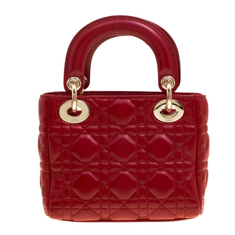 The Lady Dior tote was designed in 1994 and is now one of the most popular styles from Dior. Crafted in a sturdy, boxy silhouette, this mini-sized bag is crafted with red leather featuring the signature Canngae pattern all over. It is equipped with