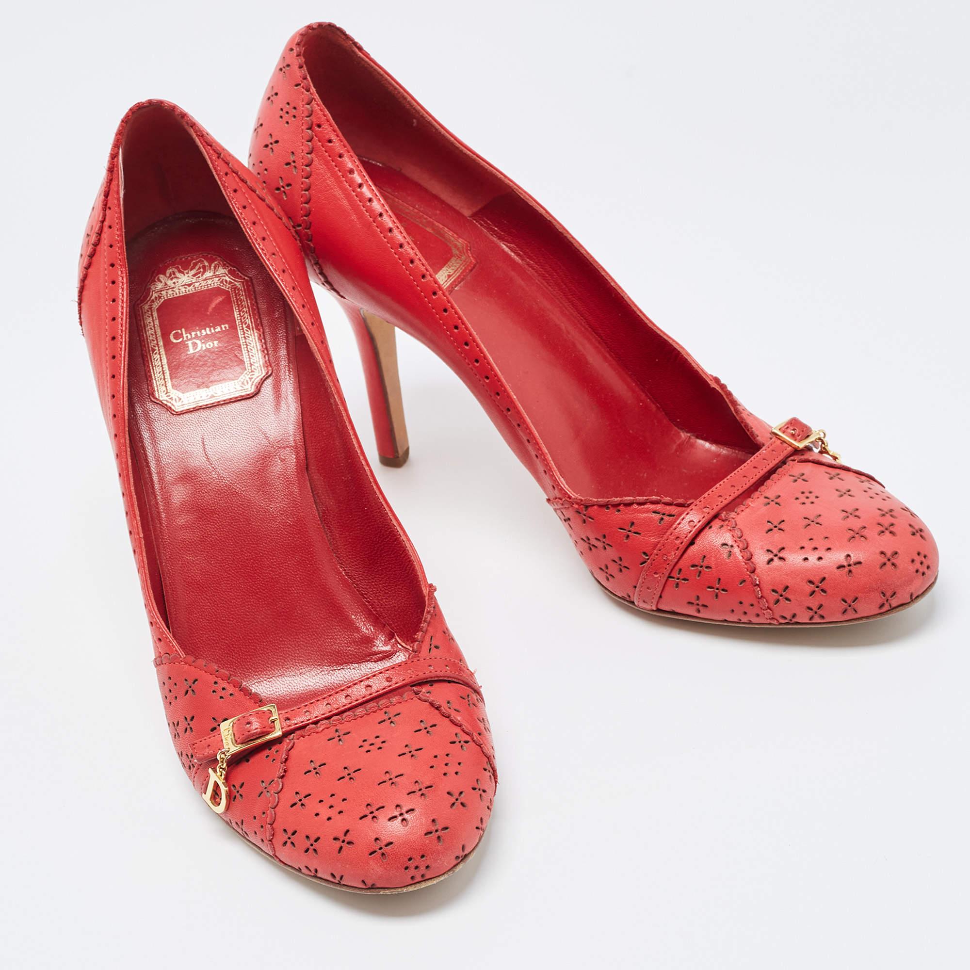 Look chic and make an elegant style statement in this pair of pumps from the leading luxury house of Dior. They are crafted from leather featuring round toes, high heels, an understated shade of red, and a lovely finish. Add a touch of
