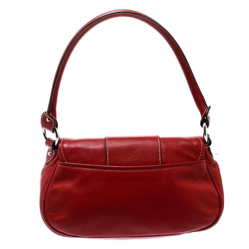 Luxuriously crafted, this red Dior bag is splendid to flaunt this season. Get set go in this trendy yet delicate leather piece. Its nylon lined interior helps in the neat storage of all your belongings and the CD on the front easily spells luxury.

