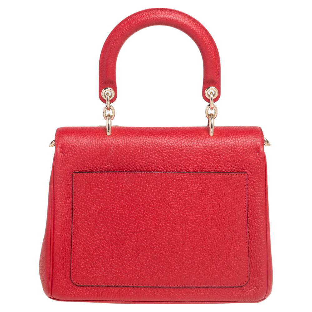 This Be Dior bag from the house of Dior is sure to add sparks of luxury to your wardrobe! It is crafted from leather and features a chic silhouette. It flaunts a single rolled top handle with attached 'DIOR' letter charms and comes equipped with