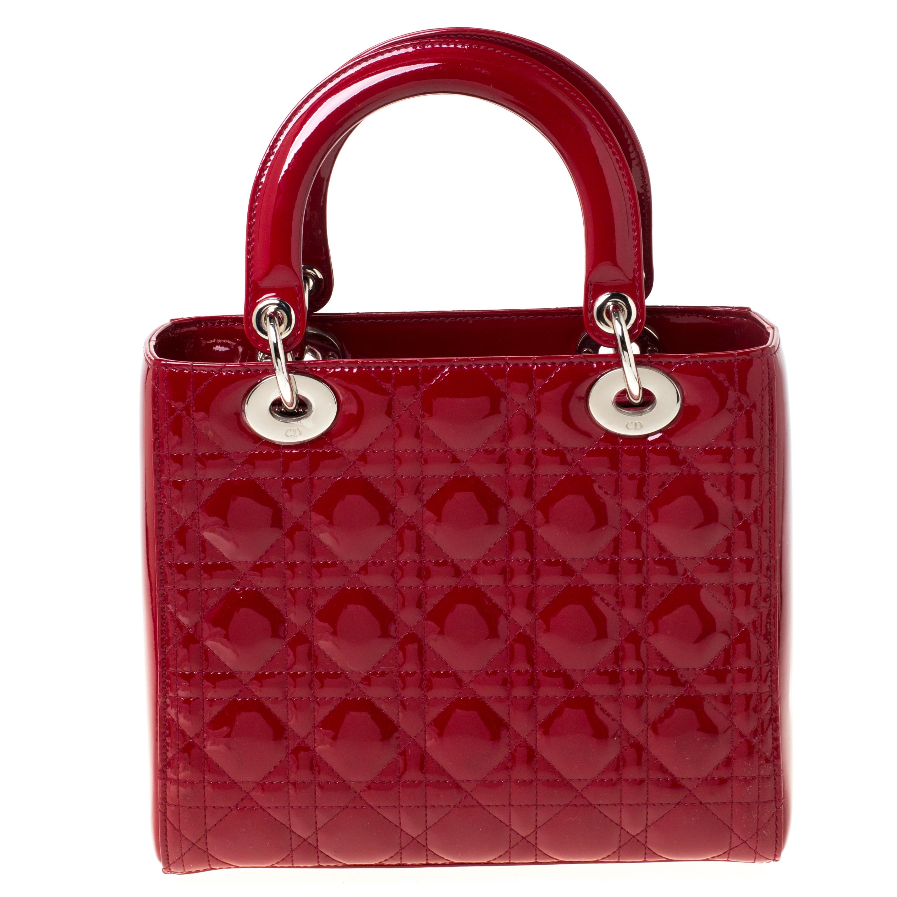 The Lady Dior tote from Dior is remarkable and highly coveted since its birth, and this one is a medium version of this iconic bag. This bag is a complete joy to witness! It comes meticulously crafted from red patent leather and designed in their