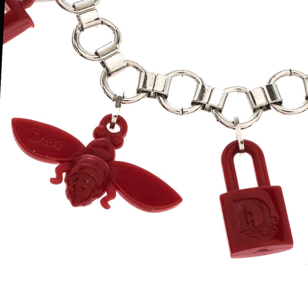 Simple breathtaking in appeal, this Dior bracelet is made from silver-tone metal and assembled with pretty charms rendered in red resin. The chain link adds the extra touch of beauty to the bracelet.

