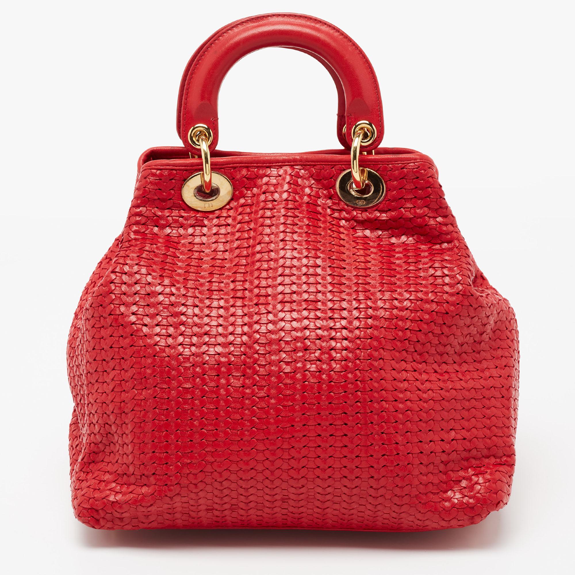 This pre-owned Dior tote is a timeless piece that can last you season after season. This bag is made of woven leather and will effortlessly accompany you to work and after. It has a red shade, brand charms, dual handles, and a suede interior.

