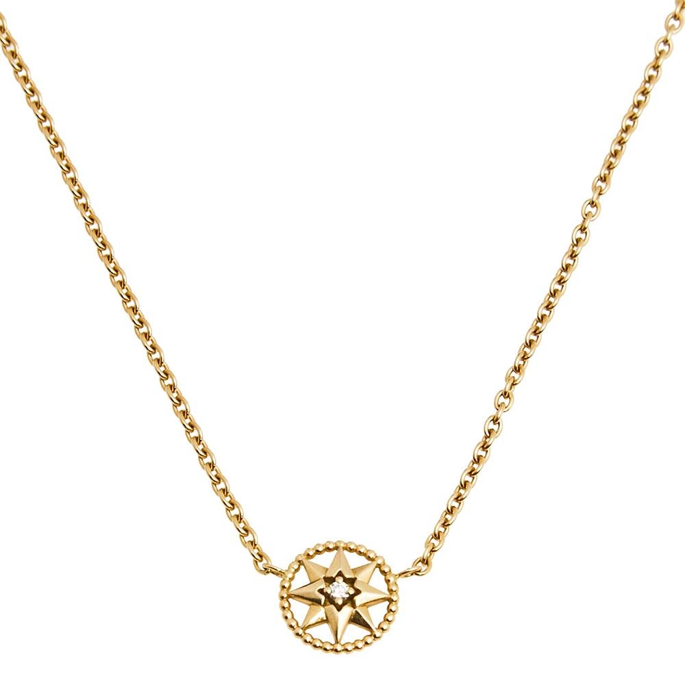 This Rose des Vents necklace by Dior exhibits the talisman star as its main highlight. The necklace's design features a round motif at the center outlined with 18k yellow gold beaded borders. The motif is further accented with a gold star that holds