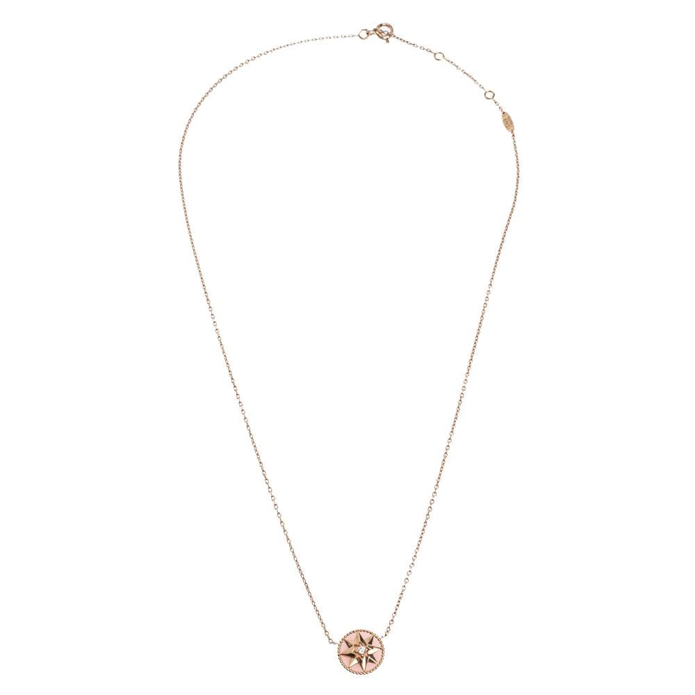 This Rose des Vents necklace by Dior exhibits the talisman star as its main highlight. The necklace's design features a round motif at the centre inlaid with shiny opal gemstone and outlined with 18k rose gold beaded borders. The motif is further