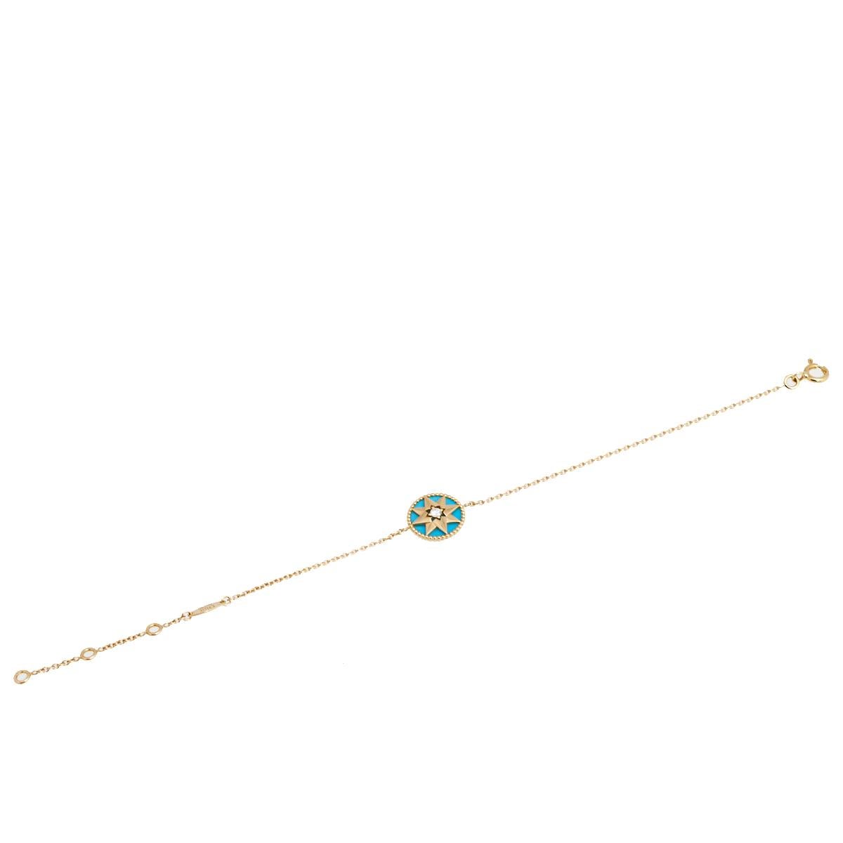 This Rose des Vents bracelet by Dior exhibits the talisman star as its main highlight. The bracelet's design features a round motif at the center inlaid with shiny turquoise gemstone and outlined with 18k yellow gold beaded borders. The motif is