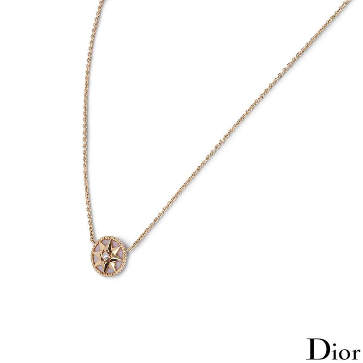 An 18k rose gold diamond and pink opal Dior necklace from the Rose des Vents collection. The necklace features a pink opal circular motif with a rose gold star set to the centre with a round brilliant cut diamond with an approximate weight of