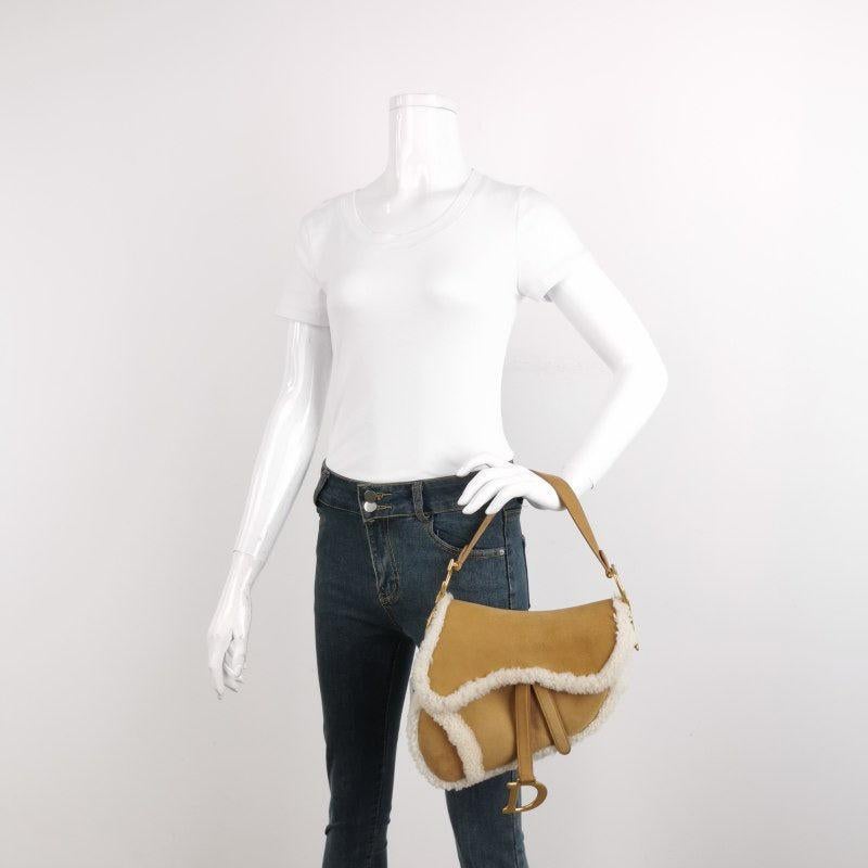 Dior Saddle 2020 Shoulder Bag Shearling Brown and While
These are professional photos of the actual bag.
  Add a wild touch to your style with this Dior Saddle bag. Unleash your inner risk-taker with this bold and chic statement piece designed by