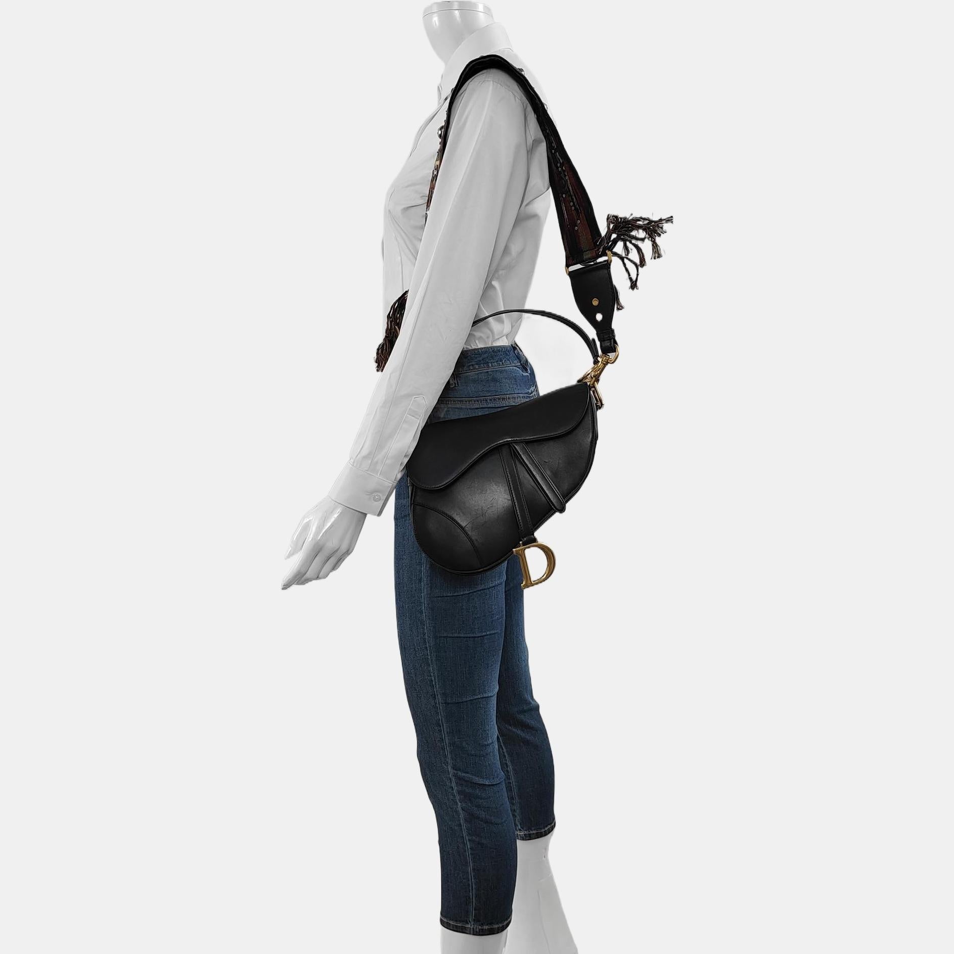 Dior Saddle Medium Cuir lisse noir avec sangle cloutée
Il s'agit de photos professionnelles du sac offert par Luxbags.

Sac Saddle Dior, réalisé en cuir de veau lisse noir, le modèle légendaire est proposé en taille moyenne, avec un rabat magnétique