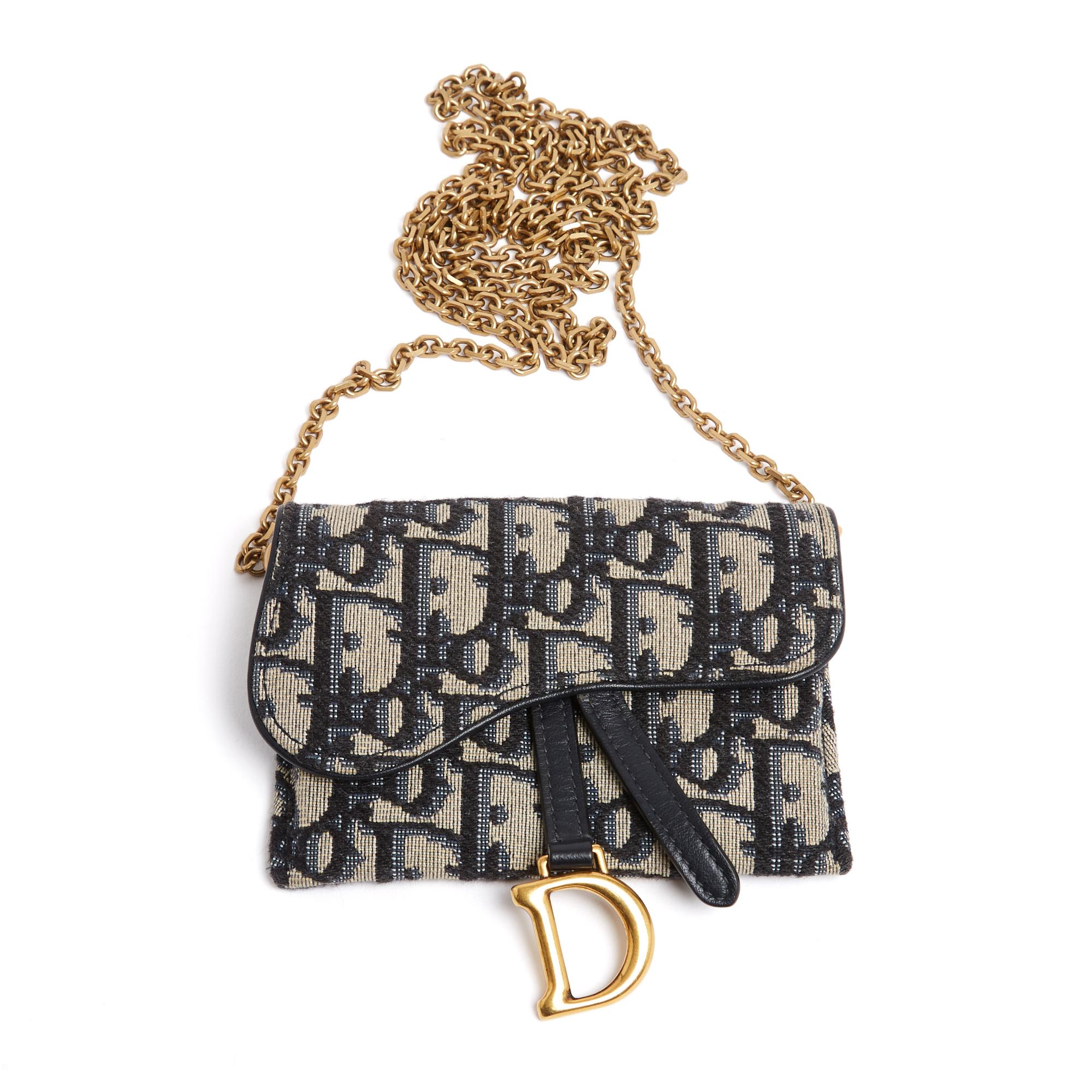 Dior Saddle mini clutch, wallet on chain style or belt clutch in blue Oblique jacquard canvas, navy blue leather and slightly aged gold metal, blue leather interior, Saddle flap closure with magnetic snap, long removable chain shoulder strap in aged