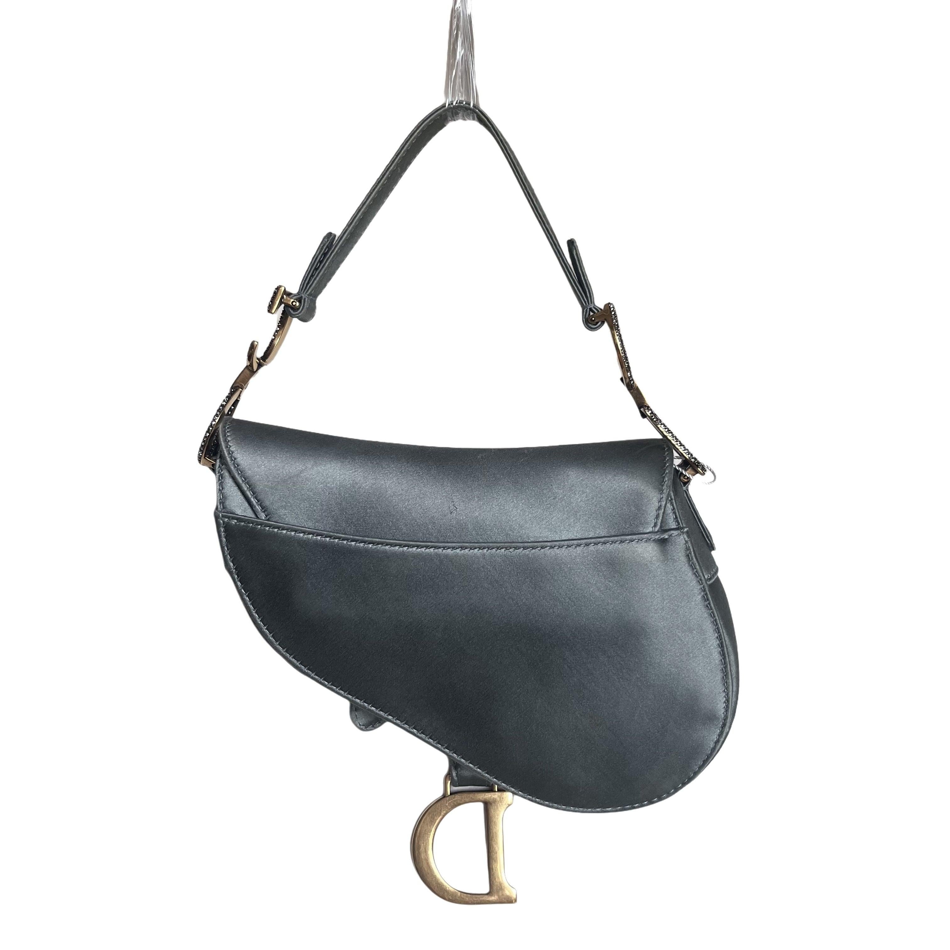 Dior Saddle Mini Silk Blue Grey with Crystal Embedded Buckles
  These are professional photos of the actual bag.
  Dior Saddle bag, crafted in blue silk satin, the legendary design comes in size mini, features a magnetic flap, and bedazzling crystal