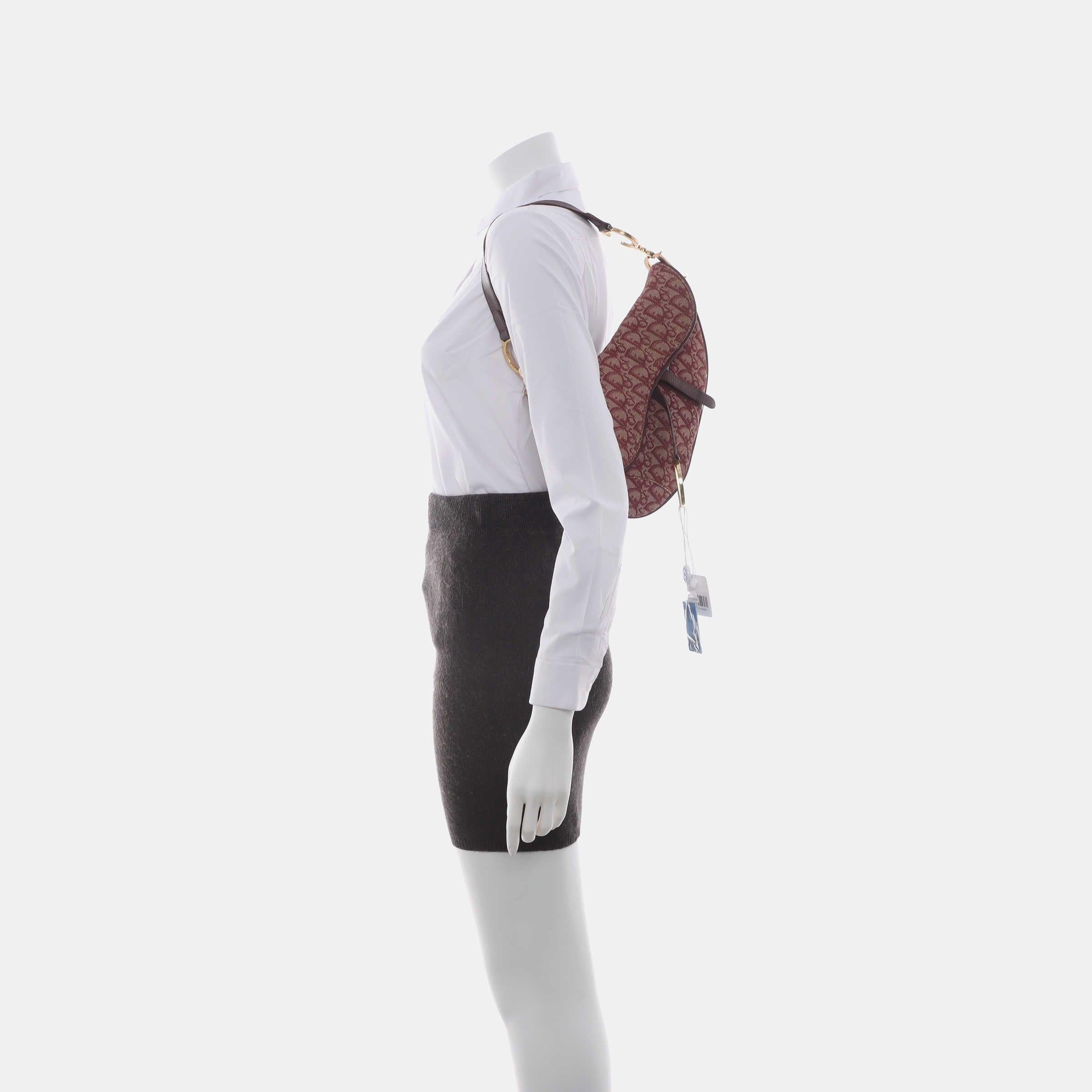 Dior Saddle Vintage Red Burgundy Oblique These are professional photos of the actual bag offered by Luxbags. The Dior Saddle Vintage Burgundy Oblique is an iconic kidney-shaped saddle bag, originally designed by John Galliano. Its most iconic