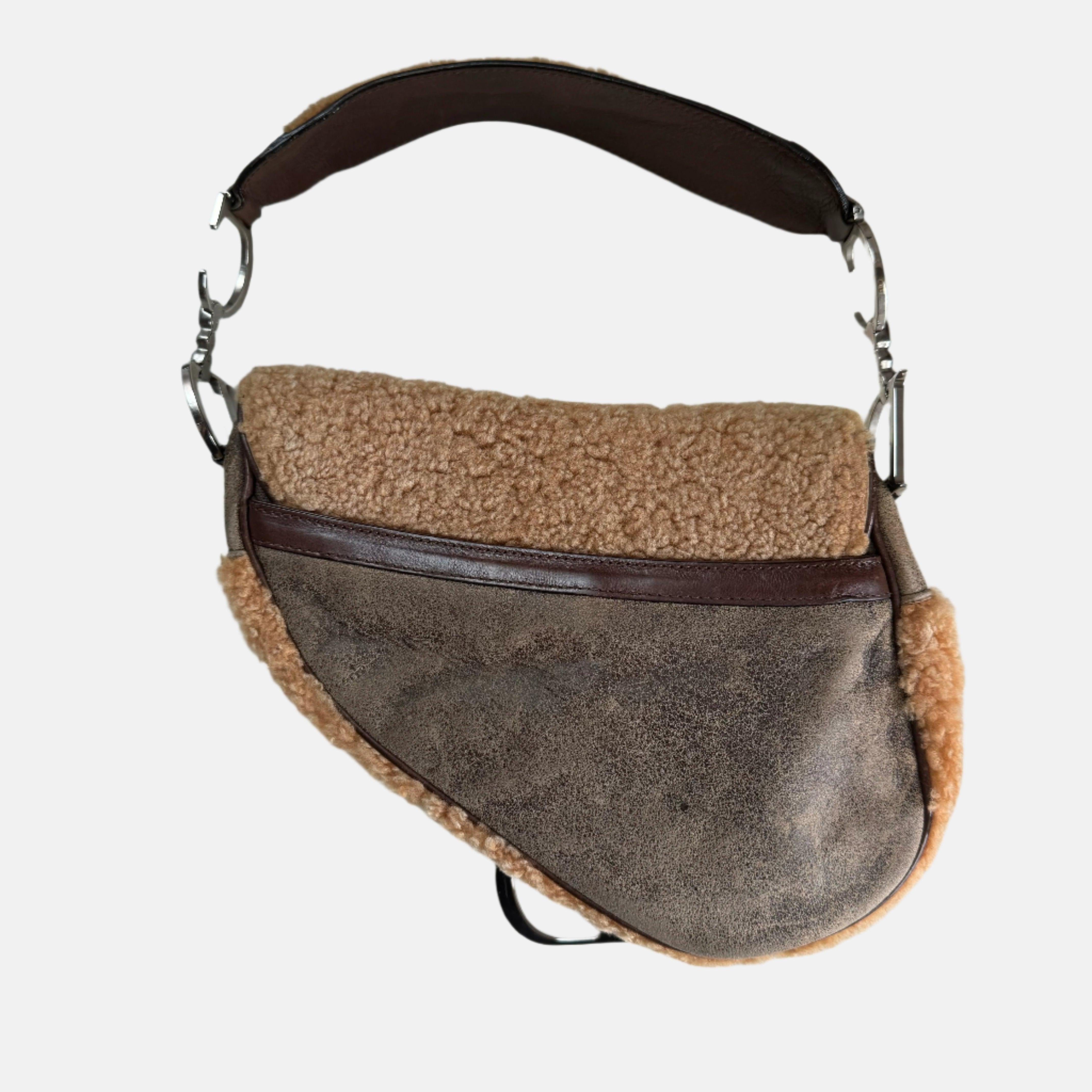 Dior Saddle Vintage Shoulder Bag Shearling Brown and While
 These are professional photos of the actual bag offered by Luxbags.
 Add a wild touch to your style with this Dior Saddle bag. Unleash your inner risk-taker with this bold and chic