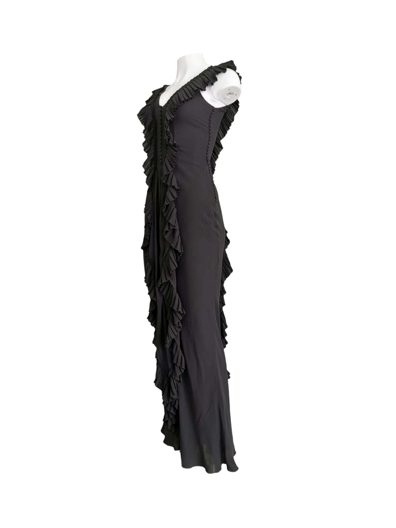 Beautiful silk black ruffle gown with button up detail on the left side and in the centre of the bust from the Galliano for Dior FW 2005 collection.

Size: UK 10

Material: Silk

Condition: Excellent

