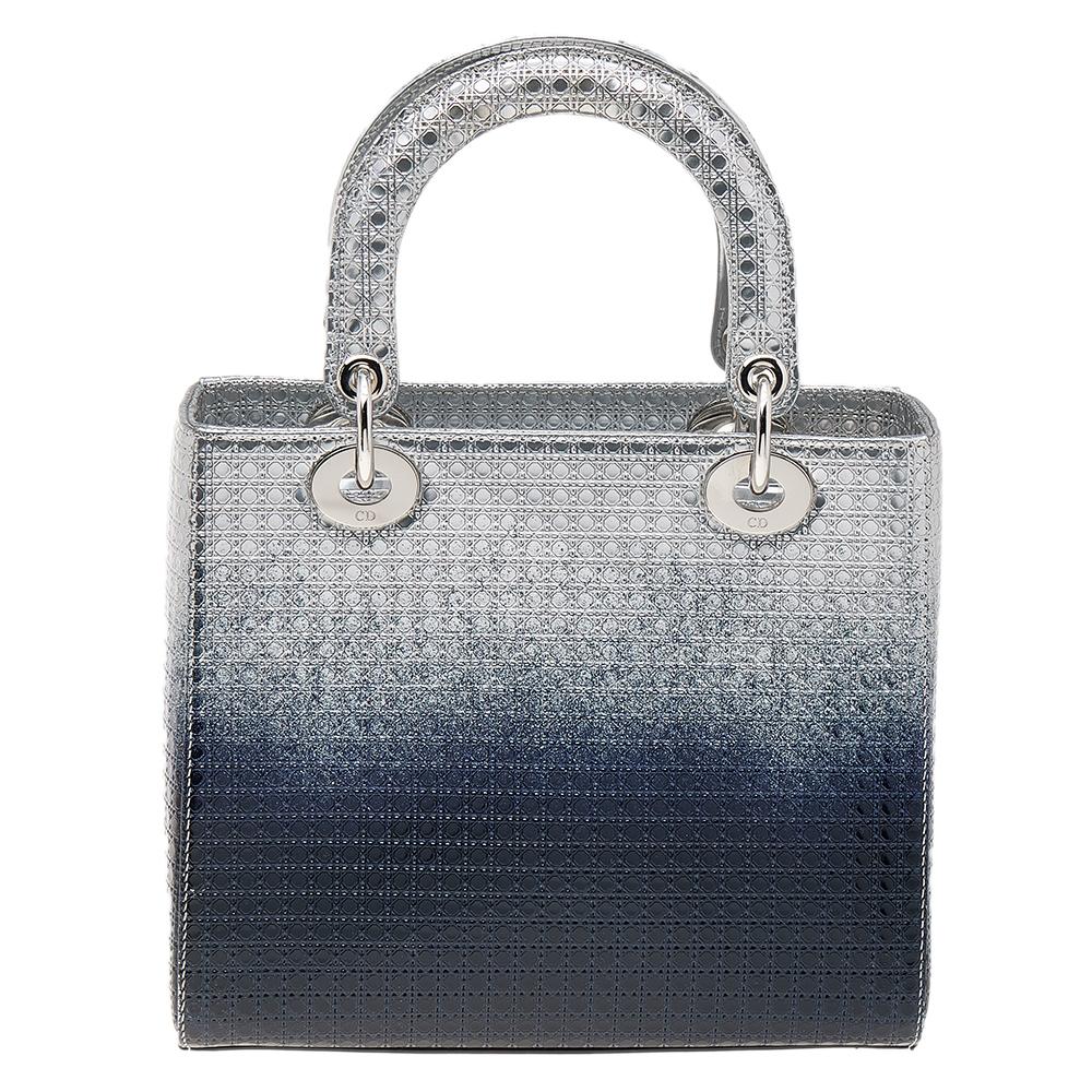 A timeless status and great design mark the Lady Dior tote. It is an iconic bag that people continue to invest in to this day. We have here this classic beauty crafted from silver/blue ombre Microcannage leather. The bag has a lined interior for