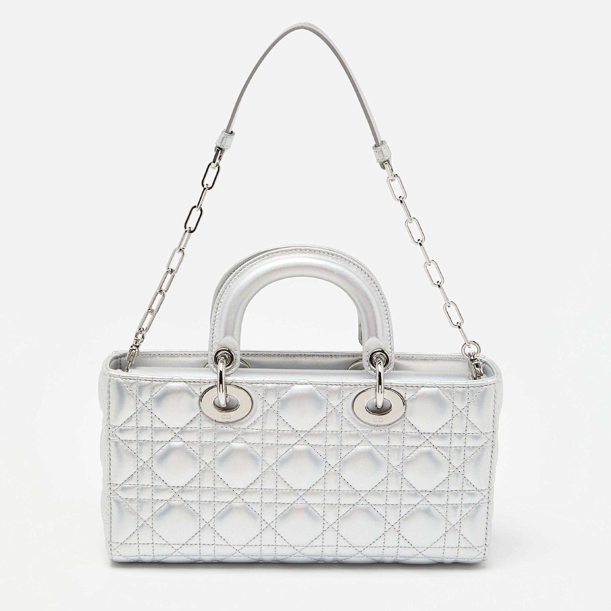 The Dior Lady D-Joy Tote epitomizes luxury with its signature quilted pattern and metallic finish. The medium-sized tote features impeccable craftsmanship, a spacious interior, and iconic Dior charm, making it a timeless and sophisticated accessory