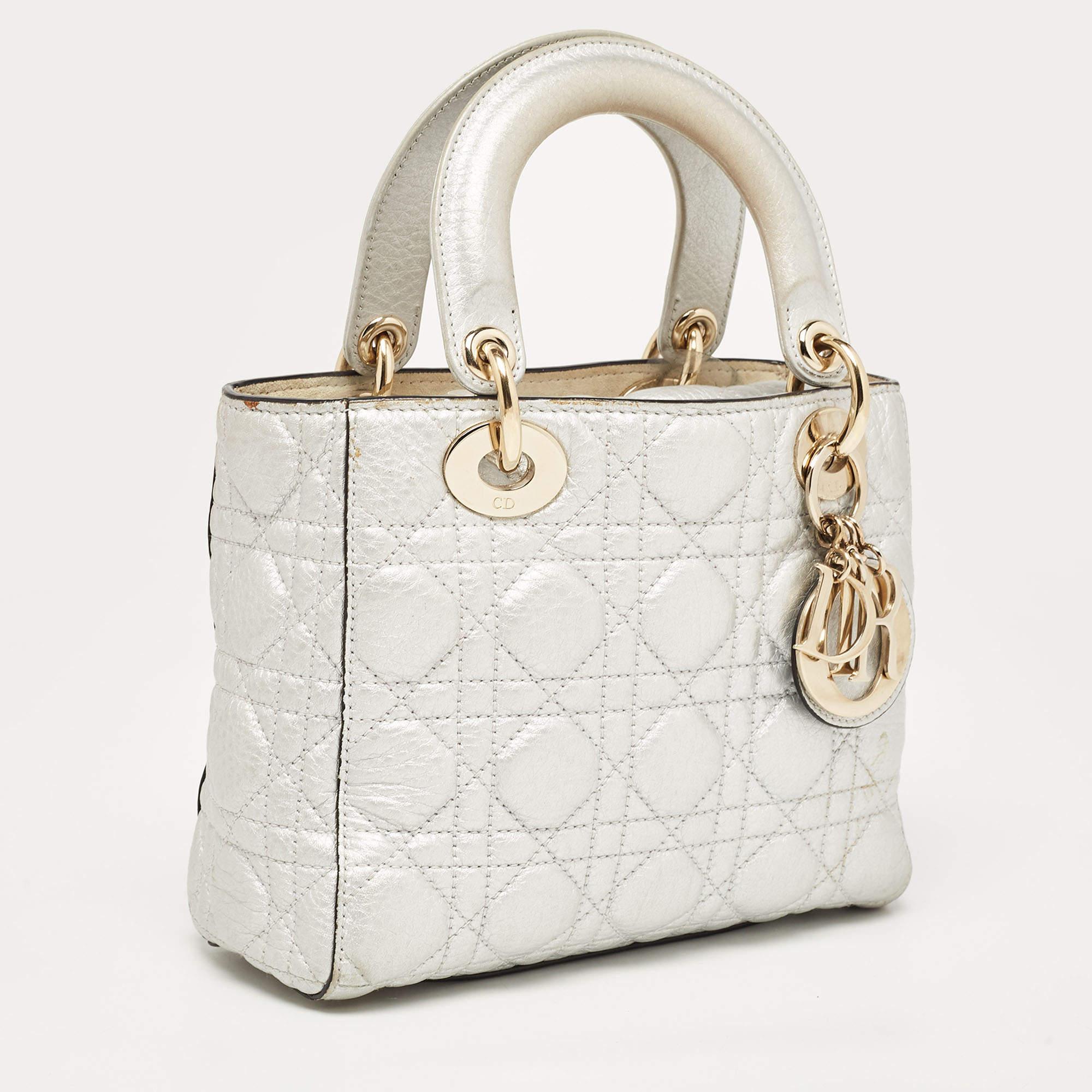 A timeless status and great design mark the Lady Dior tote. It is an iconic bag that people continue to invest in to this day. We have here this Lady Dior in silver. It's light, cute, and super pretty.

