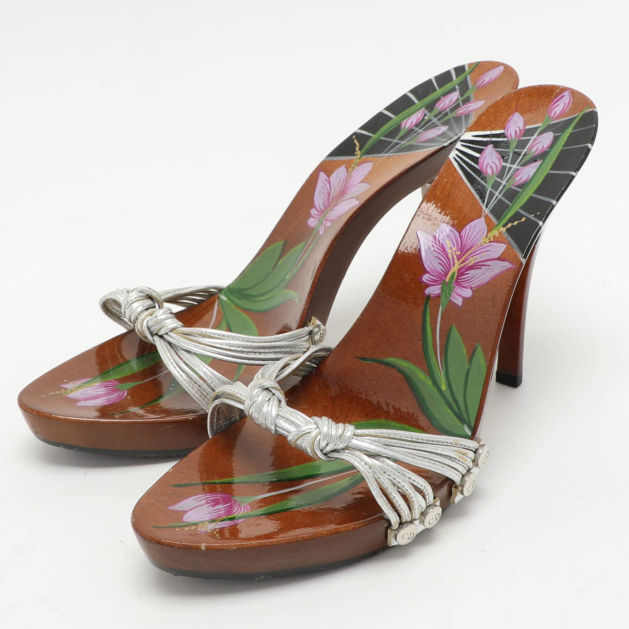 Endless compliments will come your way every time you wear these Dior sandals. These sandals are crafted from leather and styled with knotted vamp straps. They are complete with beautifully designed wood insoles  platforms and 13cm heels.