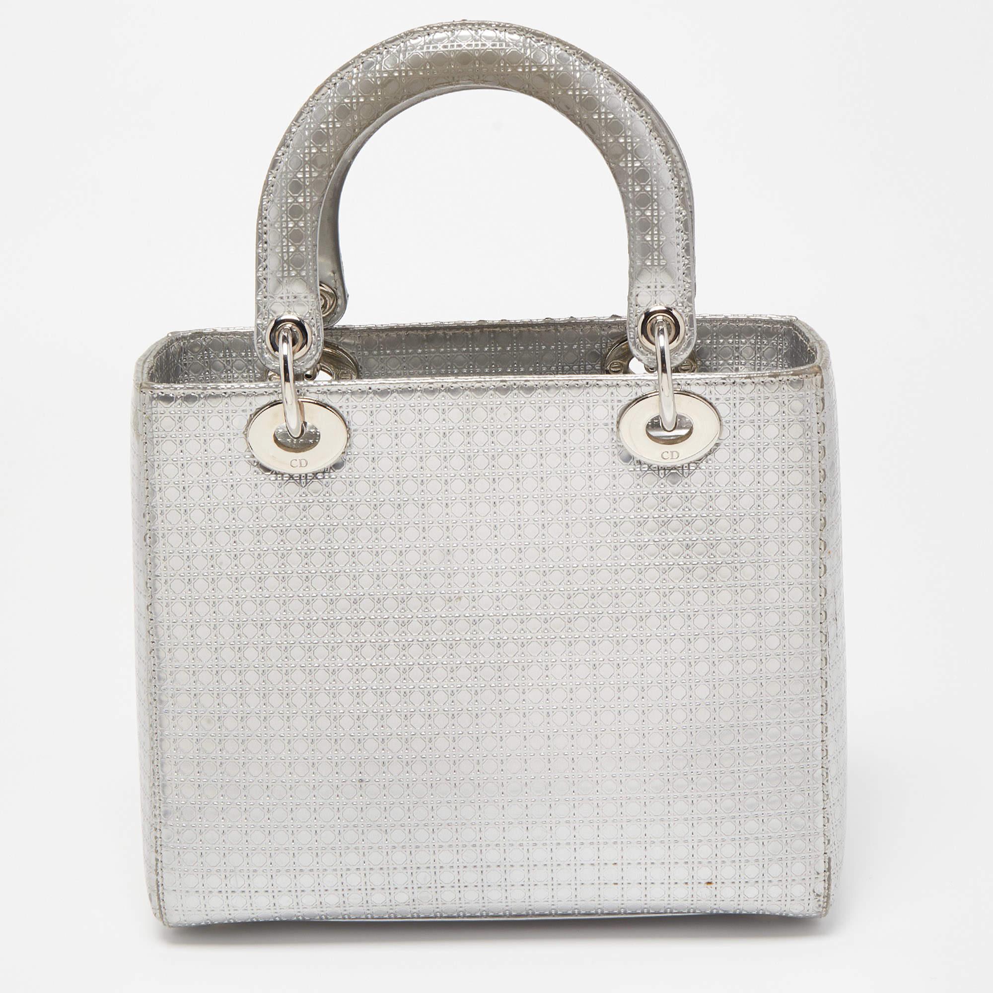 The Lady Dior tote is a Dior creation that has gained recognition worldwide and is today a coveted bag that every fashionista aims to own. This silver tote has been crafted from patent leather and it carries the signature microcannage quilt. It is