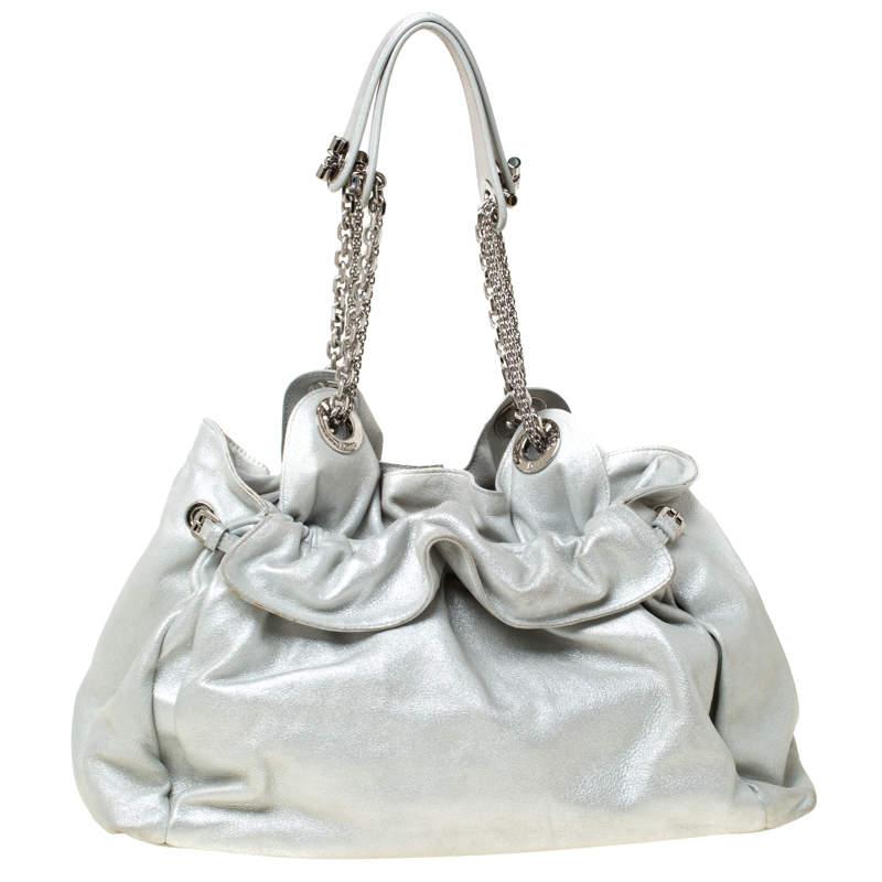 This stylish Le Trente hobo from Dior has been crafted from suede and styled with their signature cannage pattern. The bag features dual chain straps with leather shoulder rest, a CD cutout charm, a drawstring closure and protective metal feet at
