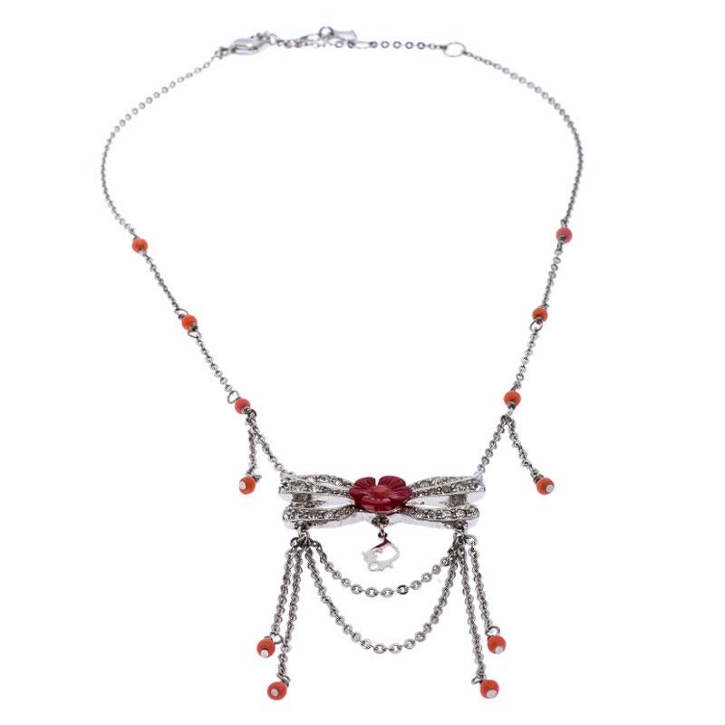 It is definitely Love At First Sight with this Dior necklace. Beautifully designed with silver-tone metal, the piece has gorgeous resin beads and a floral bow pendant enhanced with crystals and dangling chains. The neckpiece is complete with a