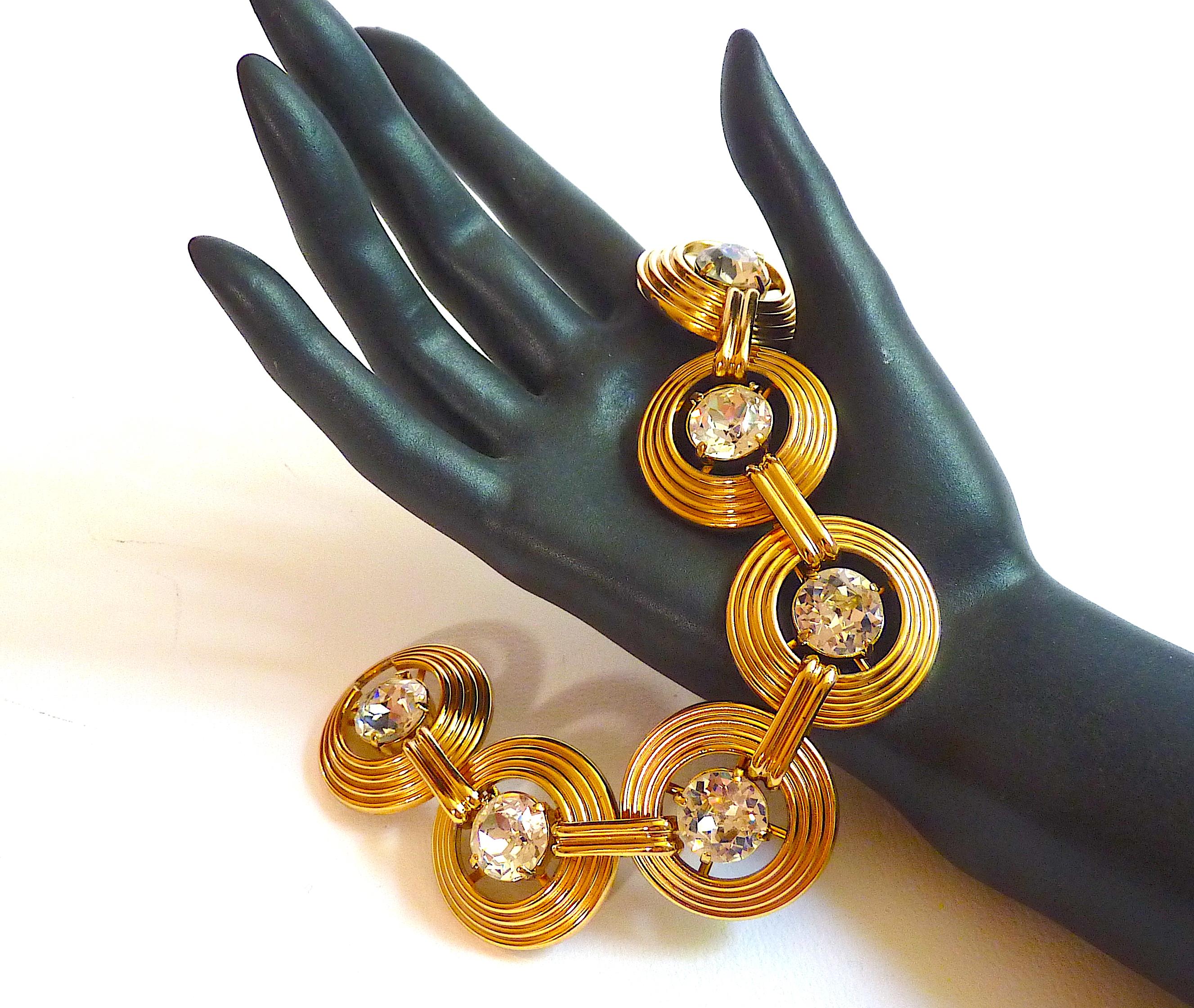 CHRISTIAN DIOR Bracelet, Art Deco Style, composed of Gold Metal Links adorned with Large Clear Crystal Cabochons, Vintage form the 70s

Signed Chr. Dior Germany inside the clasp. Until 1980s, Dior Jewelries were manufactured in Germany by the famous