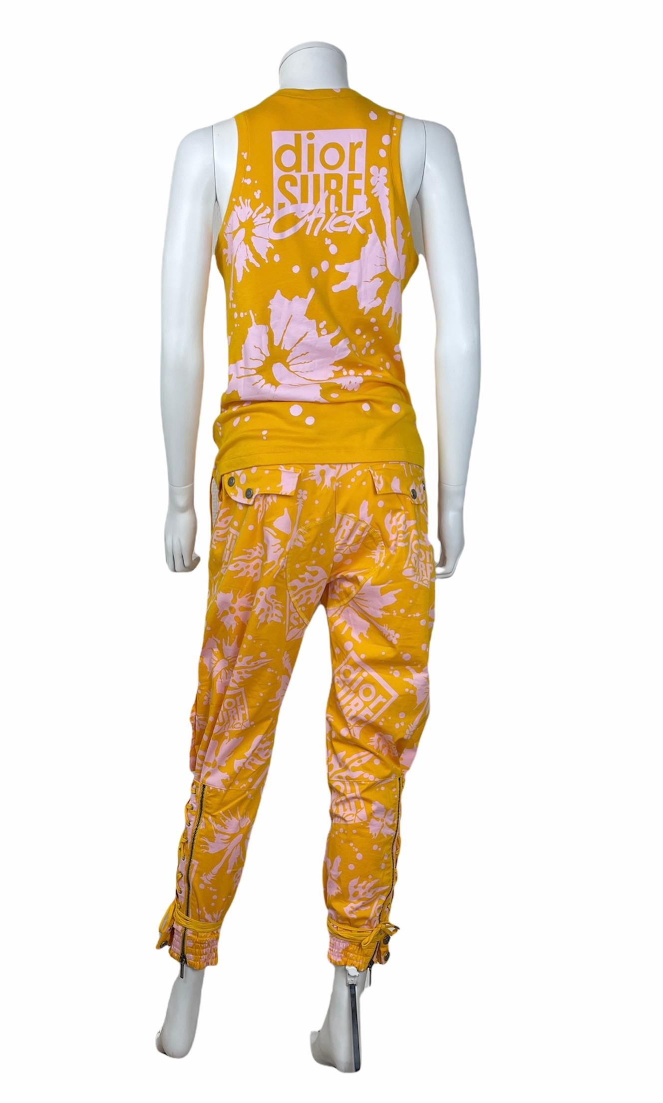 CHRISTIAN DIOR BY JOHN GALLIANO, Resort 2004, Made in Portugal.
Set of 2 yellow and pink pieces composed of a tank top with lace-up detailing and a pair of trousers with zippers on the legs and a lace-up detailing also. 
Good condition 
Tag size is