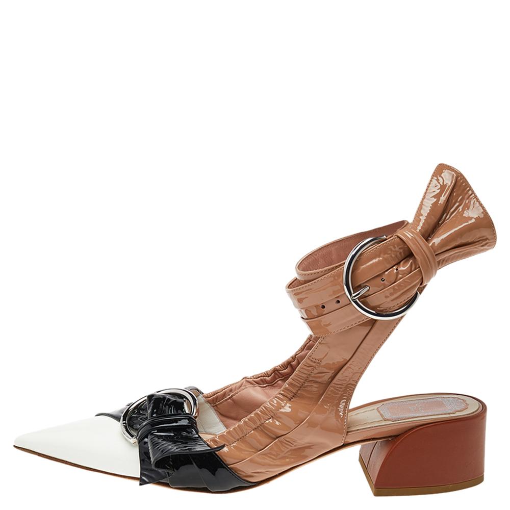 These sandals from Dior are absolutely stunning. Crafted from glossy patent leather, they flaunt multicolored hues and exude effortless style. They are styled with pointed toes, buckle detailing on the uppers, ankle wraps with buckle closure, 8 cm