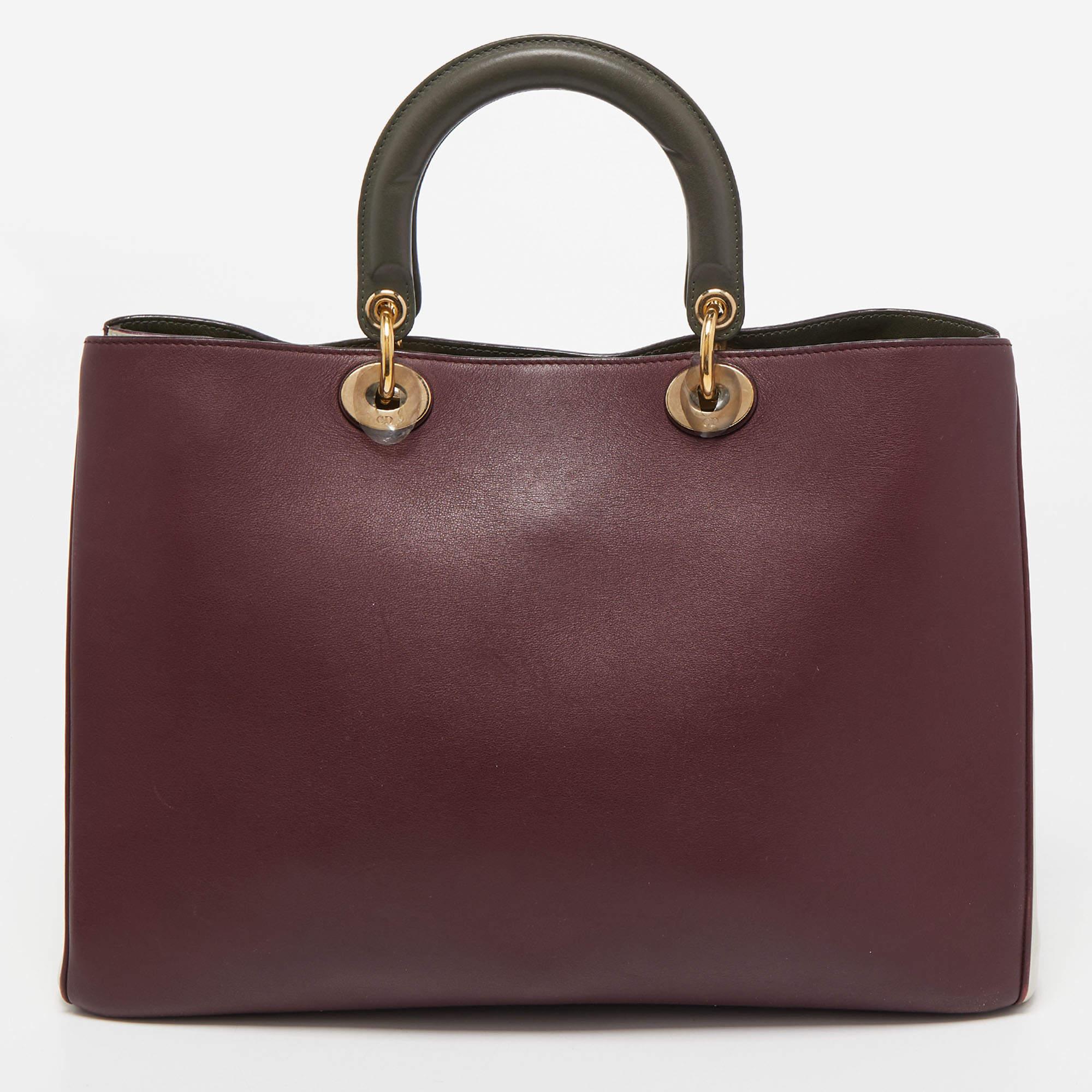 This Diorissimo Shopper tote from the House of Dior will help you keep your belongings safely and stylishly. It is made using leather on the exterior and is highlighted with D.I.O.R charms on the front. It features dual handles, a shoulder strap,