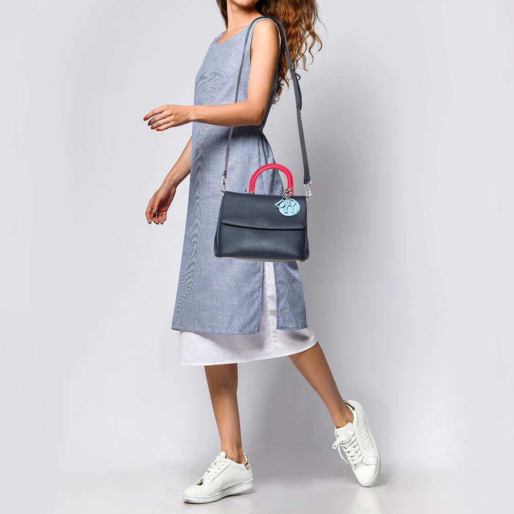 Pretty in a two-tone blue palette, this Dior bag is crafted from leather and designed with a front flap and a contrasting single top handle. The leather-lined interior houses an open compartment that can easily accommodate your daily essentials and