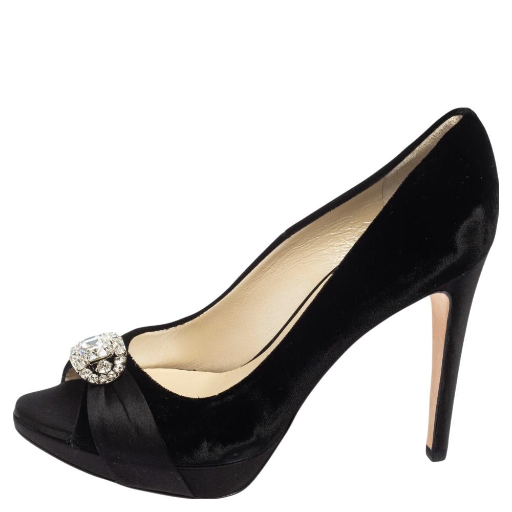 A great pair to wear to work and even on regular days, these Dior black velvet and satin pumps deliver a refined appeal. The pumps feature peep toes, crystal embellishments on the uppers, platforms, and 11.5 cm heels.

Includes: Original Box, Info