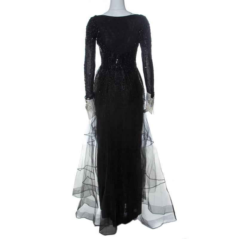 Let this black Dior gown help you radiate your beauty in an effortless way. The design thought along with the construction and execution are what adds value to the wonder that emanates from the gown. It comes with a heavily embellished bodice, long