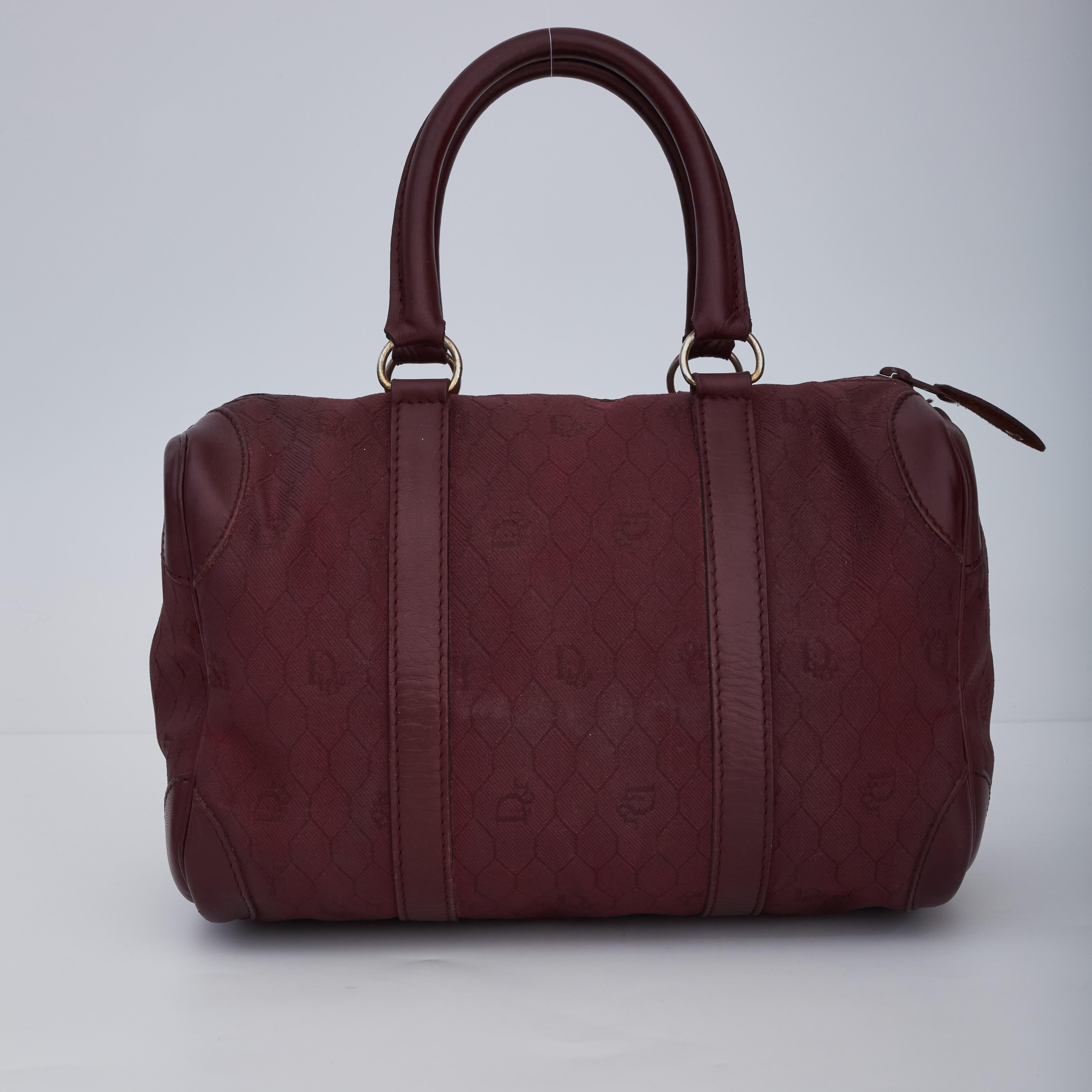 COLOR: Burgundy
MATERIAL: Canvas
MEASURES: H 7” x W 10” x D 6”
DROP: 5”
CONDITION: Very good - faint hairline marks, darkening to rolled leather handles, bag was refurbished and dyed professionally.

Made in France
